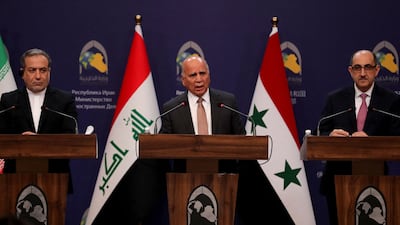 Iraqi Foreign Minister Fuad Hussein, centre, Iranian Foreign Minister Abbas Araghchi, left, and Syrian Foreign Minister Bassam Sabbagh during a press conference after a meeting in Baghdad on Friday. AFP