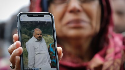 Akhtar Khokhur, 58, shows a picture of her husband Mehaboobbhai Khokhar during an interview outside an information centre for families in Christchurch, New Zealand. AP Photo