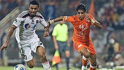 Al Jazira's Khalid Sabeel, left, and Ajman's Mohammed Yakoub race for the ball last night.