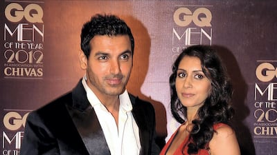 Abraham with girlfriend Priya Runchal, receiving the Most Stylish Man award during the GQ Men of the Year Awards in Mumbai on September 30, 2012. AFP Photo.