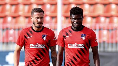Atletico Madrid's Saul Niguez, left, and Thomas Partney.