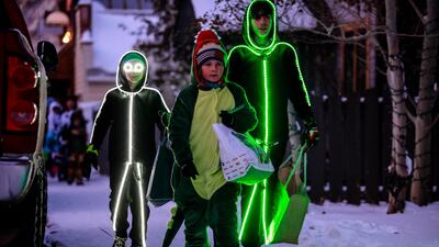 Kids lit up walk down the street during the annual Minturn, Colo., trick or treat, in Minturn, Colo. Warm costumes were all the rage at this year's event. AP Photo