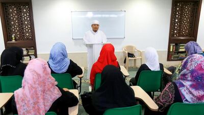 Dr Nasser Raciles, office administrator at the New Muslim Centre, discuss with Muslim converts the plans to send zakat al fitr, charity given to the poor at the end of Ramadan, to The Phillippines. Ravindranath K / The National