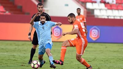 Dibba's Ahmed Al-Nuqbi looks to keep possession past a Sharjah defender. Courtesy Arabian Gulf League