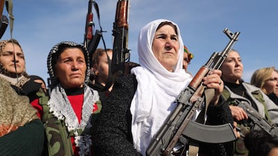 Kurdish civilians gather in Qamishli after a call to arms by the Syrian Democratic Forces. The army has sent reinforcements to flashpoint areas in northern Kurdish strongholds. AFP