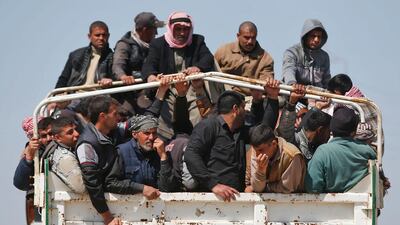 Displaced Iraqis, who fled their homes in the Old City in western Mosul because of the ongoing fighting between government forces and ISIL, being taken to the Hammam Al Alil camp, south of Mosul, on March 27, 2017. Ahmad Gharabli/AFP