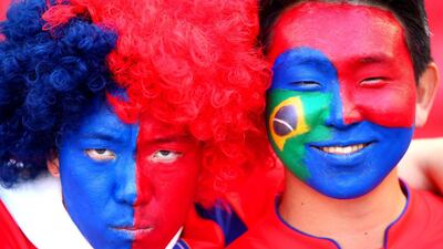 South Korea fans with painted faces enjoy the atmosphere prior to their team's match against Algeria on Sunday at the 2014 World Cup. Jeff Gross / Getty Images