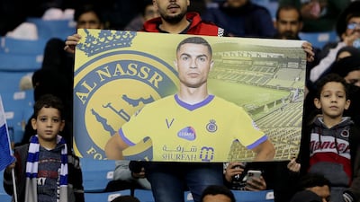 A fan holds up a banner of Al Nassr's Cristiano Ronaldo inside the stadium before the match. Reuters
