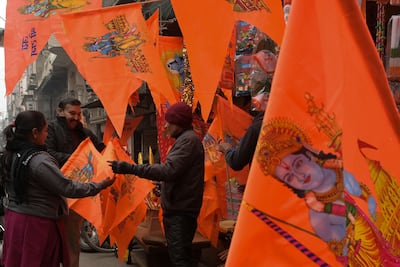 People buy flags printed with pictures of Hindu deity Ram and Ram Temple in Ayodhya, from a shop in Amritsar on January 19, 2024. AFP