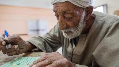 Esmail Ahmed , 82 years old, casts his ballot at a polling station during the final day of the first round of parliamentary election, in Fayoum, Egypt. Eman Helal / AP Photo