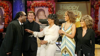 Oprah Winfrey wears a white shirt and trouser set on 'The Oprah Winfrey Show' with Stevie Wonder, John Travolta, Gayle King and Tina Turner in Chicago on January 29, 2004. EPA
