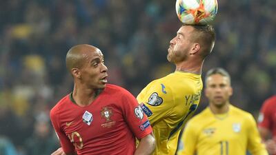 Portugal midfielder Joao Mario and Ukraine forward Andriy Yarmolenko vie for the ball. AFP