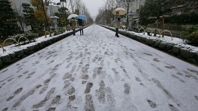 People walk in the snow outside Tsurugaoka Hachimangu Shrine in Kamakura, near Tokyo. Shizuo Kambayashi / AP Photo