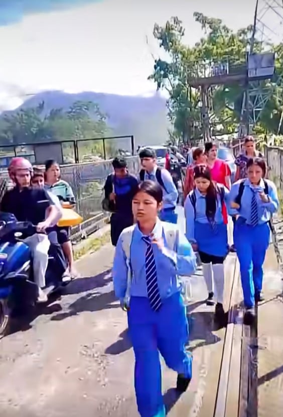 Pupils flee after floodwaters crashed into the school on August 26. Harisharan Gajurel / Facebook