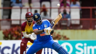 Nicholas Pooran, left, of West Indies, watches as Suryakumar Yadav, right, of India, hits another boundary during the third T20I. AFP