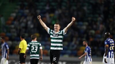 Sporting Lisbon's Eric Dier, centre, celebrates victory over Porto after their Portuguese league match at Alvalade stadium in Lisbon on March 16, 2014. Rafael Marchante / Reuters