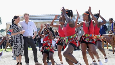 CAPE TOWN, SOUTH AFRICA - SEPTEMBER 23: Meghan, Duchess of Sussex and Prince Harry, Duke of Sussex smile as they visit a Justice Desk initiative in Nyanga township, during their royal tour of South Africa on September 23, 2019 in Cape Town, South Africa. The Justice Desk initiative teaches children about their rights and provides self-defence classes and female empowerment training to young girls in the community. (Photo by Chris Jackson/Getty Images)