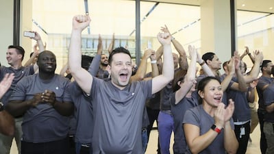 Apple employees cheer and celebrate. The two stores in Dubai and Abu Dhabi will have 150 staff between them with 30 different nationalities speaking 40 different languages. Sarah Dea / The National
