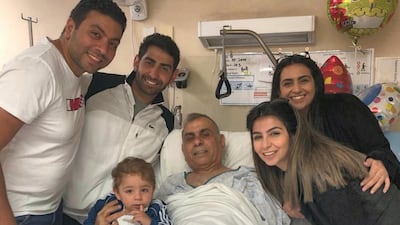 Adeeb Sami, 53, pictured surrounded by his family at Christchurch Hospital, has now been allowed to continue his recovery at home.