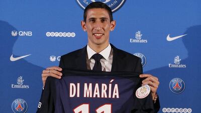 Angel Di Maria poses with his new Paris Saint Germain jersey after a news conference in Paris. Ian Langsdon / EPA/