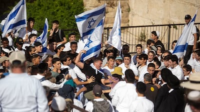 Israelis attack a woman during the Jerusalem Day Flag March. Getty Images
