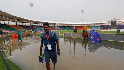 A man wades through rain waters after cancellation of the Pakistan v Sri Lanka ODI cricket match due to rain at the National Stadium in Karachi, Pakistan. Reuters