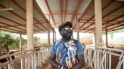 Ba stands in a stable from which he rears cattle adjacent to his Senegal studio. Cooper Inveen / Reuters