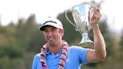 Dustin Johnson celebrates with the Tournament of Champions Cup.
