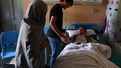 Relatives visit an injured pupil in hospital. The school targeted was reported to be the Abdul Rahim Shaheed High School. AFP