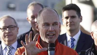 Swiss pilot Bertrand Piccard addresses the media shortly after landing. EPA