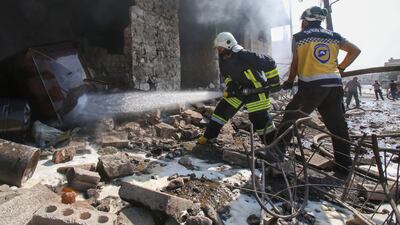 Members of the Syrian Civil Defence, also known as the "White Helmets", extinguish fire following an airstrike by regime forces in Maaret al-Numan in northwest Syria. Russian and Syrian regime aircraft have since late April ramped up the deadly bombardment of the Idlib region of some three million people in northwest Syria, despite a deal to avert a massive government assault. AFP