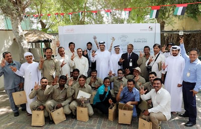 Staff gather with head of leisure facilities Khalid Al Suwaidi on the last day before Dubai Zoo closes. Chris Whiteoak / The National
