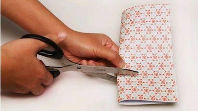 Cut along the marked lines. Tina Chang / The National