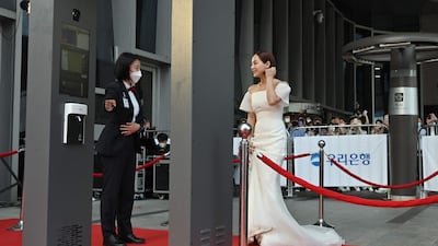 Actress Eugene walks through a thermal camera system as she arrives on the red carpet of the 56th annual Daejong Film Awards in Seoul. AFP