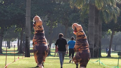 Two entrants don inflated T-Rex costumes to take part in the Inflatable heat race. Leslie Pableo for The National