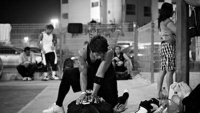 A members of the Black team helps their Captain, Benji Bogal stretch prior to a finals match.