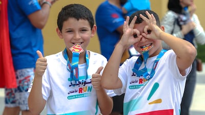 Louqman Fettabe, 10, and Harone Fettabe, 9, with their medals after the run
