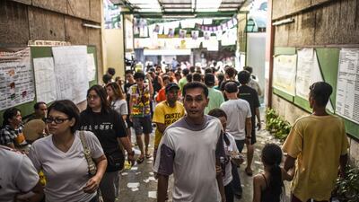 Filipino voters enter a polling station during the presidential election in Manila. Voting was under way in the Philippines on May 9 to elect a new president, with anti-establishment firebrand Rodrigo Duterte the shock favourite after an incendiary campaign in which he vowed to butcher criminals. Mohd Rasfan / AFP