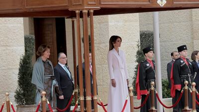 Jordan's Queen Rania, centre, walks with Norway's Queen Sonja, left, on the reviewing stand. AP Photo