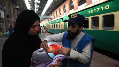 A health worker administers polio drops to a child at a railway station during a polio vaccination campaign in Lahore on November 5, 2019. Arif Ali / AFP