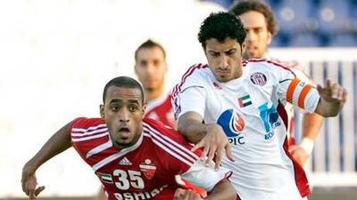 Al Ahli’s Abdulla Abdulrahman, left, and Ali Saleh Abdulla, of Al Jazira, chase after the ball during first-half action.