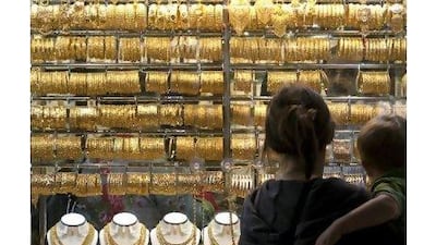 Window shoppers peruse a display of gold jewellery outside a store in the Gold Souk in Dubai. A reader notes that while diamonds may be forever, gold's increasing value makes it a smarter investment. (Jeff Topping/The National)