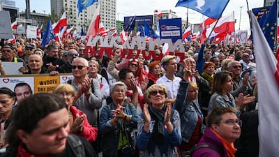 People hold Polish and EU flags during the 'March of a Million Hearts' on October 1 in Warsaw, Poland. Getty Images