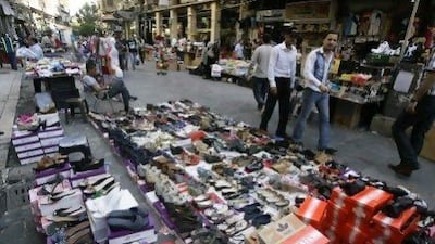 Syrian street vendors display shoes and clothes for sale in a pedestrian area in downtown Damascus. AFP PHOTO/JOSEPH EID