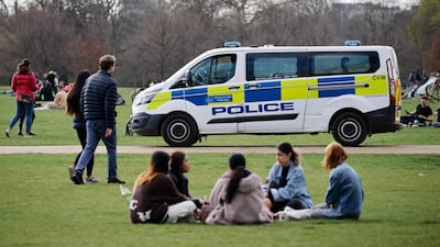 A police van patrols as people relax in Hyde Park. AFP