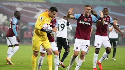 West Ham United's Lukasz Fabianski celebrates with Vladimir Coufal, Tomas Soucek and teammates after saving the penalty from Fulham's Ademola Lookman. Reuters
