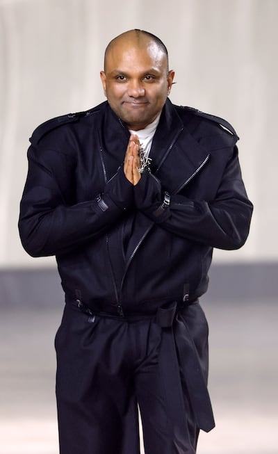 Indian fashion designer Gaurav Gupta acknowledges the applause of the audience at the end of his show. Getty Images