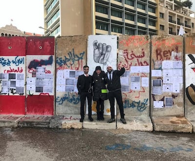Roudy Hanna, left, and Mark Darido, right pose next to the 'wall of qualifications' - a concrete security barrier near parliament. Courtesy Mark Darido