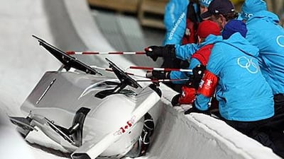 The Canada 1 bobsleigh comes to rest after flipping on the 13th turn at Whistler.