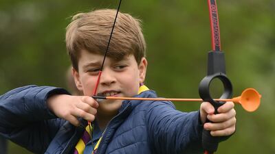 Prince George of Wales tries his hand at archery at the 3rd Upton Scouts Hut, in Slough, near London. Getty
